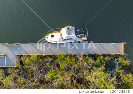Capsized sunken sailing boat left forsaken on shallow bay waters after hurricane Ian in Manasota, Florida 120423208