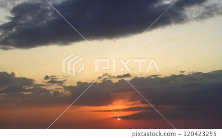 Beautiful sunset sky scenery. Bright colorful orange and yellow clouds on horizon Beautiful sunset sky scenery. Bright colorful orange and yellow clouds on horizon 120423255