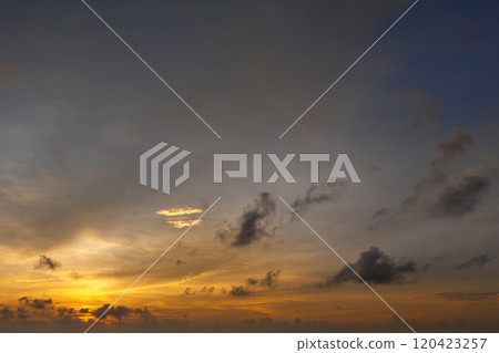 Beautiful sunset sky scenery. Bright colorful orange and yellow clouds on horizon 120423257
