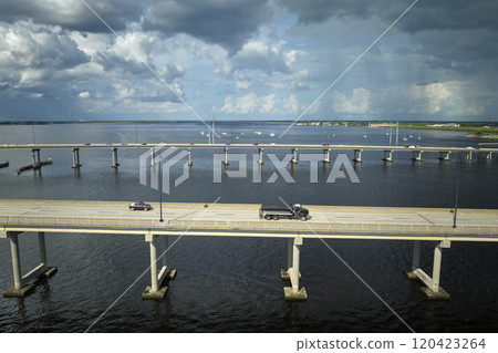 Barron Collier Bridge and Gilchrist Bridge in Florida with moving traffic. Transportation infrastructure in Charlotte County connecting Punta Gorda and Port Charlotte over Peace River 120423264