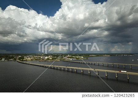 Barron Collier Bridge and Gilchrist Bridge in Florida with moving traffic. Transportation infrastructure in Charlotte County connecting Punta Gorda and Port Charlotte over Peace River Barron Collier Bridge and Gilchrist Bridge in Florida with moving traffic. Transportation infrastructure in Charlotte County connecting Punta Gorda and Port Charlotte over Peace River 120423265