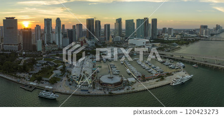American urban landscape at sunset. Skyviews Miami Observation Wheel at Bayside Marketplace with reflections in Biscayne Bay water and high illuminated skyscrapers of Brickell, city's financial center 120423273