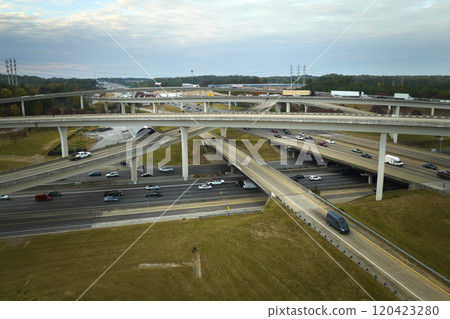 American freeway intersection with fast driving cars and trucks. View from above of USA transportation infrastructure American freeway intersection with fast driving cars and trucks. View from above of USA transportation infrastructure 120423280