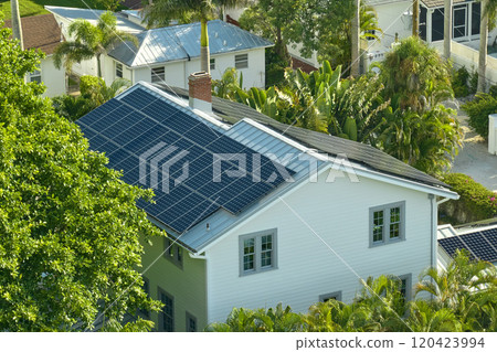 Aerial view of new expensive american building roof with rows of blue solar photovoltaic panels for producing clean ecological electric energy. Renewable electricity with zero emission concept 120423994