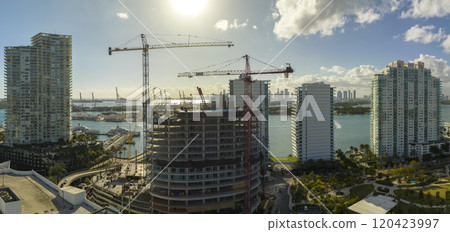 Aerial view of new developing residense in american urban area. Tower cranes at industrial construction site in Miami, Florida. Concept of housing growth in the USA 120423997