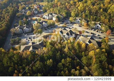 Aerial view of new apartment houses between yellow trees in South Carolina suburban area in fall season. Real estate development in american suburbs Aerial view of new apartment houses between yellow trees in South Carolina suburban area in fall season. Real estate development in american suburbs 120423999