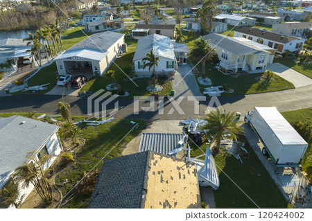 Aerial view of natural disaster consequences in Florida Southwest region. Severely damaged by hurricane Ian mobile homes in residential area Aerial view of natural disaster consequences in Florida Southwest region. Severely damaged by hurricane Ian mobile homes in residential area 120424002