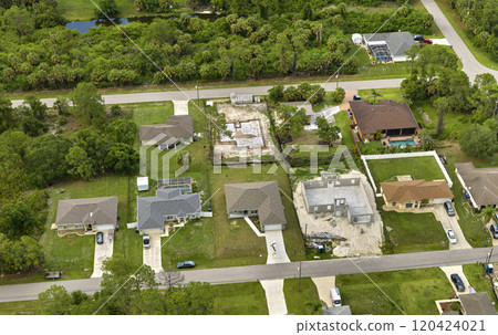 Aerial view of incompleted frame of private home under construction with brick concrete walls ready for installation of wooden roofing beams. Industrial building site Aerial view of incompleted frame of private home under construction with brick concrete walls ready for installation of wooden roofing beams. Industrial building site 120424021
