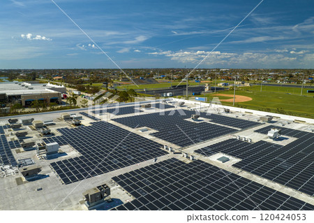 Aerial view of blue photovoltaic solar panels mounted on industrial building roof for producing clean ecological electricity. Production of renewable energy concept Aerial view of blue photovoltaic solar panels mounted on industrial building roof for producing clean ecological electricity. Production of renewable energy concept 120424053