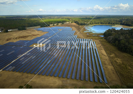 Aerial view of big sustainable electric power plant with many rows of solar photovoltaic panels for producing clean electrical energy. Renewable electricity with zero emission concept Aerial view of big sustainable electric power plant with many rows of solar photovoltaic panels for producing clean electrical energy. Renewable electricity with zero emission concept 120424055