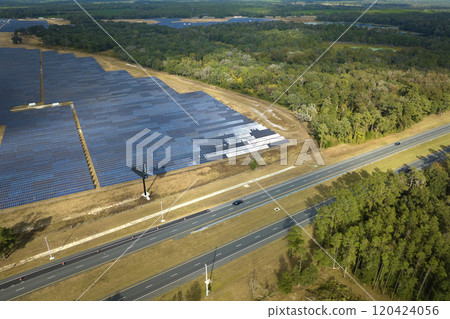 Aerial view of big sustainable electric power plant with many rows of solar photovoltaic panels for producing clean electrical energy. Renewable electricity with zero emission concept Aerial view of big sustainable electric power plant with many rows of solar photovoltaic panels for producing clean electrical energy. Renewable electricity with zero emission concept 120424056