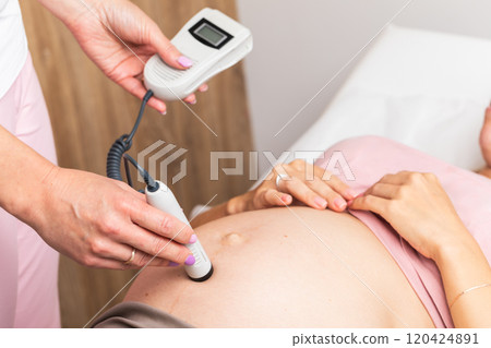 Using a fetal Doppler to monitor the heartbeat of a baby during prenatal care Using a fetal Doppler to monitor the heartbeat of a baby during prenatal care 120424891