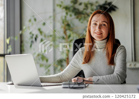 Professional Woman Working on Laptop at Home Professional Woman Working on Laptop at Home 120425172