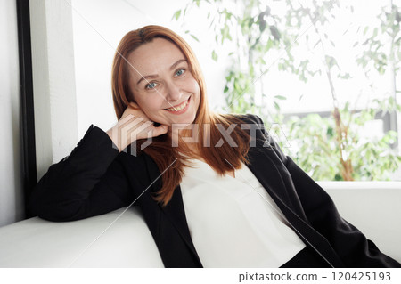 Professional Woman Smiling in Modern Office 120425193