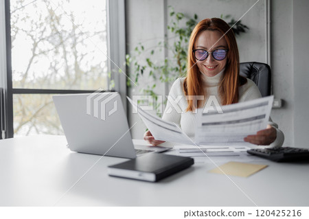 Businesswoman Analyzing Documents 120425216