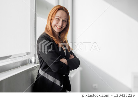 Confident Businesswoman in Sunlit Office Confident Businesswoman in Sunlit Office 120425229