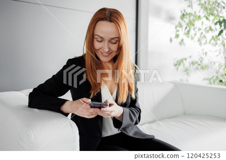 Businesswoman Using Smartphone in Modern Office Businesswoman Using Smartphone in Modern Office 120425253