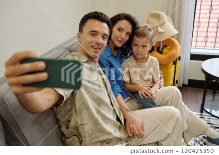 Taking Family Selfie on Comfortable Couch 120425350