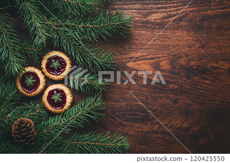 Traditional Linzer Christmas Cookies with raspberry or strawberry jam on wooden table. Top view. Copy space 120425550