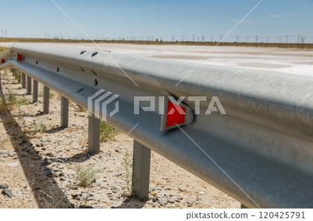 red road reflectors along the road. metal road fencing. Road and traffic safety red road reflectors along the road. metal road fencing. Road and traffic safety 120425791