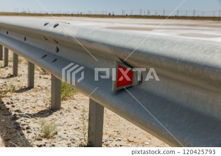 red road reflectors along the road. metal road fencing. Road and traffic safety red road reflectors along the road. metal road fencing. Road and traffic safety 120425793