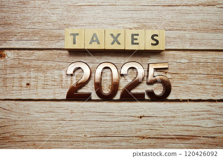 Taxes 2025 alphabet letter on wooden background Taxes 2025 alphabet letter on wooden background 120426092