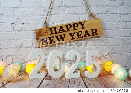 Happy New Year 2025 years number with LED cotton balls decoration on wooden background Happy New Year 2025 years number with LED cotton balls decoration on wooden background 120426276