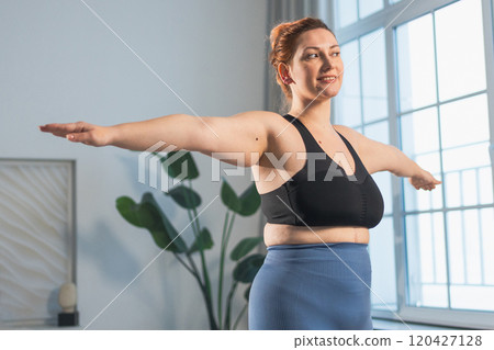 Fitness workout training. Woman practicing fitness at home. Plus size female doing sports exercise at home indoor. Girl in sportswear have workout weight training for weight loss. Sport and fitness 120427128