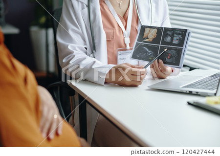 Discussing Pregnancy Ultrasound Images During Checkup Discussing Pregnancy Ultrasound Images During Checkup 120427444