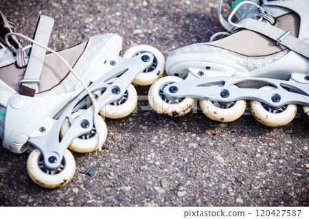 Closeup roller skates on asphalt. Closeup roller skates on asphalt. 120427587