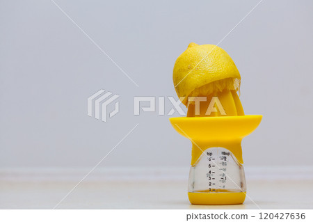 Lemon placen on juice squeezer maker 120427636