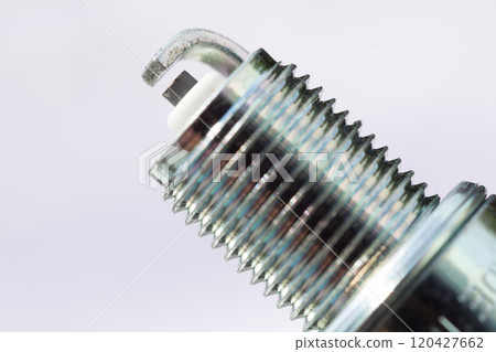 Auto service. New spark plug as spare part of car. 120427662