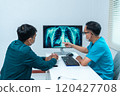 Doctor Discussing X-Ray Results with Patient 120427708