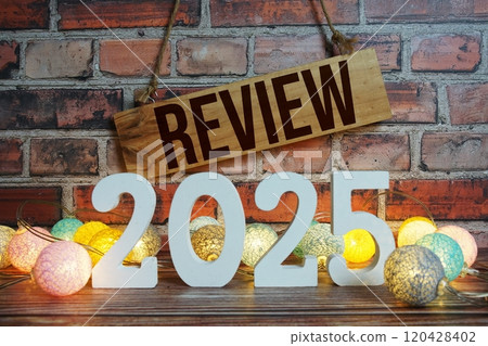 Review 2025 Happy New Year concept with LED cotton balls decoration on wooden background Review 2025 Happy New Year concept with LED cotton balls decoration on wooden background 120428402