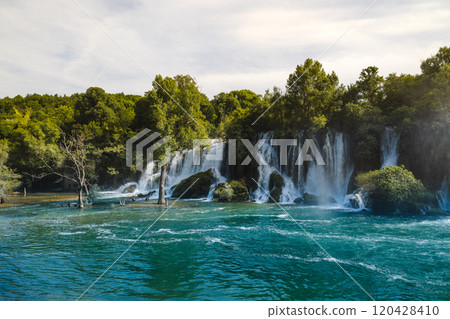 Kravica Waterfall cascade into a vibrant turquoise river in Bosnia and Herzegovina  120428410
