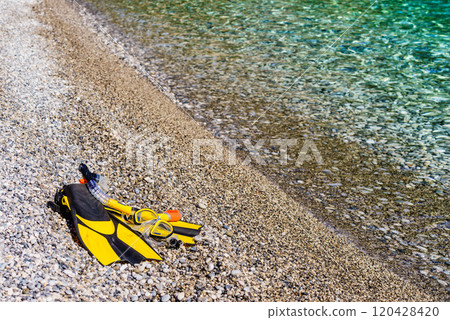 Flippers and snorkeling tube on sea shore Flippers and snorkeling tube on sea shore 120428420
