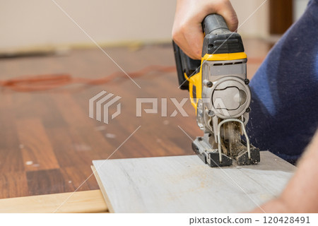 Person cutting floor panels Person cutting floor panels 120428491