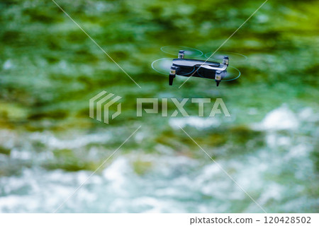 Drone flying over water nature Drone flying over water nature 120428502