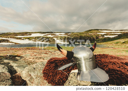 Viking helmet on lake shore, Norway Viking helmet on lake shore, Norway 120428510