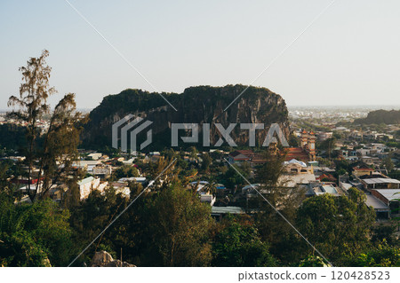 View of lush greenery and urban life surrounding the Marble Mountains in Da Nang, Vietnam during a clear day View of lush greenery and urban life surrounding the Marble Mountains in Da Nang, Vietnam during a clear day 120428523