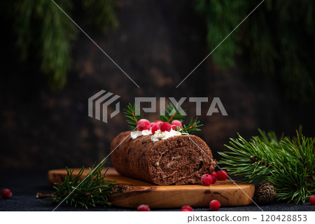 Christmas chocolate roll cake with sparkler 120428853