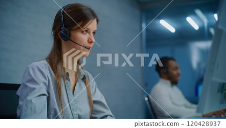 Close up of female technical support specialist in headset providing online customer service Close up of female technical support specialist in headset providing online customer service 120428937