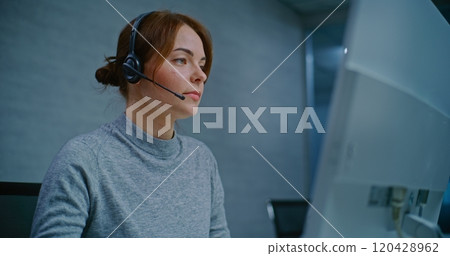 Positive female helpdesk specialist talking on headset, providing online assistance 120428962