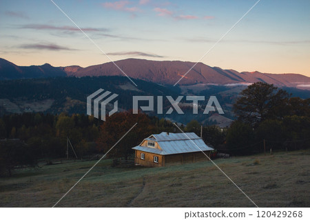 Rural house in autumn mountains earlu in the morning. Local village in Carpathian mountains, Ukraine. House in autumn forest in morning light. Eco tourism concept. Autumn weather landscape. Rural house in autumn mountains earlu in the morning. Local village in Carpathian mountains, Ukraine. House in autumn forest in morning light. Eco tourism concept. Autumn weather landscape. 120429268