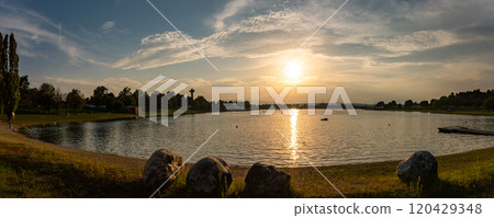 Lake schwarzl sunset panorama schwarzlsee near the styrian capitol Graz in Austria. Lake schwarzl sunset panorama schwarzlsee near the styrian capitol Graz in Austria. 120429348