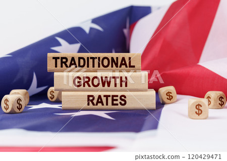 On the US flag and wooden plates with the inscription - traditional growth rates 120429471