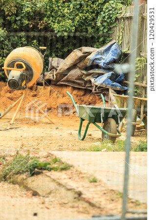 Construction site with green barrow Construction site with green barrow 120429531