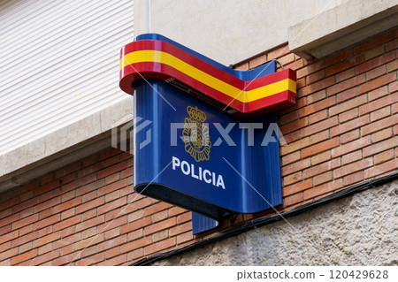 On the building hangs a sign with the inscription Police and the flag of Spain 120429628