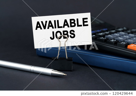On the table is a notebook, a calculator, a pen and a business card with the inscription - Available Jobs On the table is a notebook, a calculator, a pen and a business card with the inscription - Available Jobs 120429644