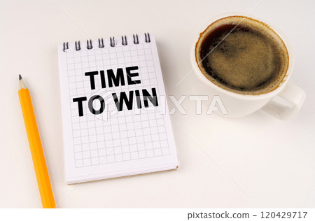 On a white surface, a cup of coffee, a pencil and a notepad with the inscription - Time to win 120429717